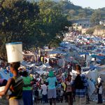 People crowd at a makeshift camp for earthquake survivors set up on a golf course in Port-au-Prince.